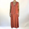 Conjunto de dos piezas en color coral terracota con chaleco sin mangas y falda larga. Diseño elegante y versátil, ideal para cualquier ocasión